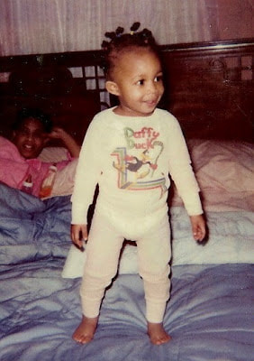 Danielle one year old standing on bed in pjs