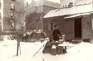 Man-in-front-of-cabin-on-115th-st-during-1897