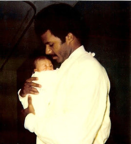 Lloyd holding Danielle one day old
