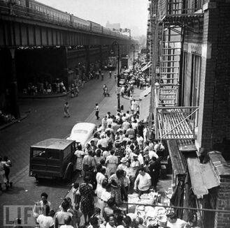 People milling around on Park Ave near La Marqueta may-64