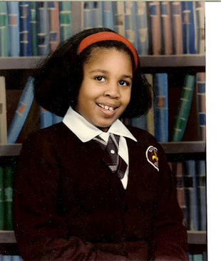 six year old girl in front of bookcase